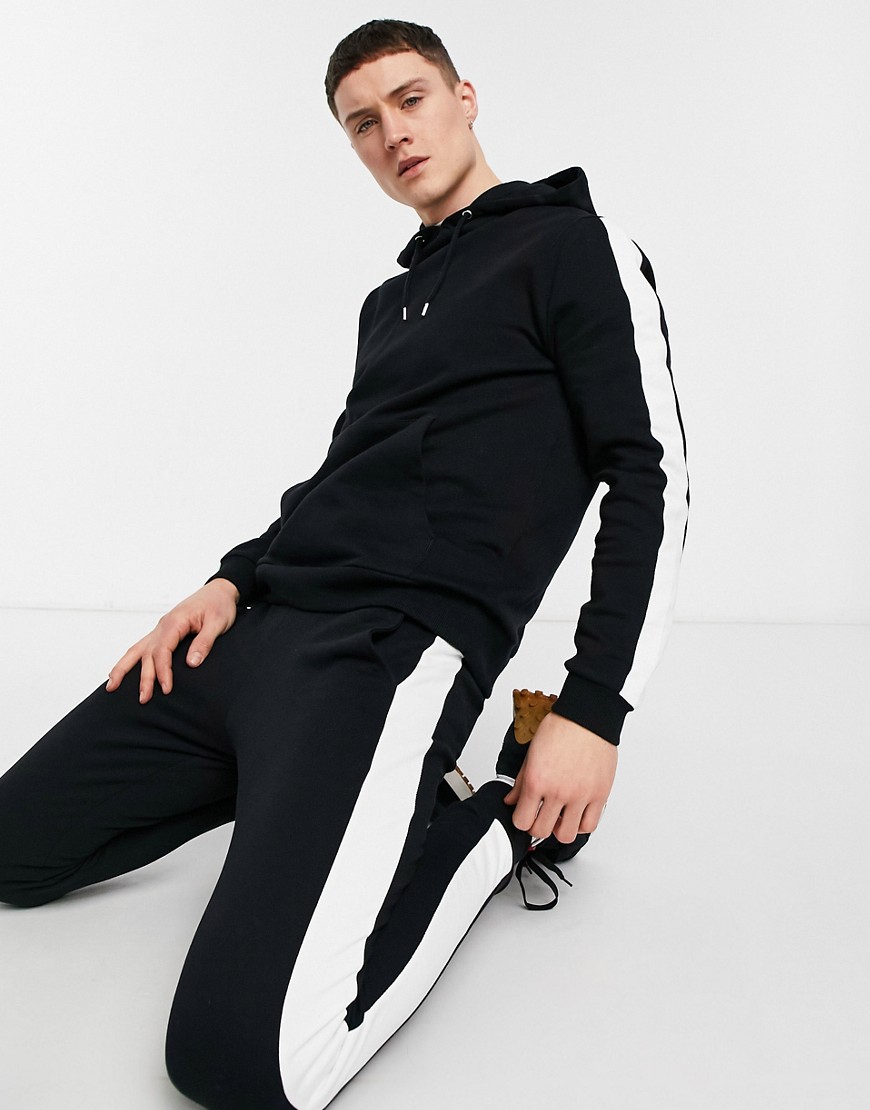 ASOS DESIGN tracksuit with side stripe in black | The Fashionisto