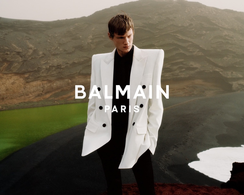 Donning a chic double-breasted blazer in white, Braien Vaiksaar appears in Balmain's spring-summer 2021 men's campaign.