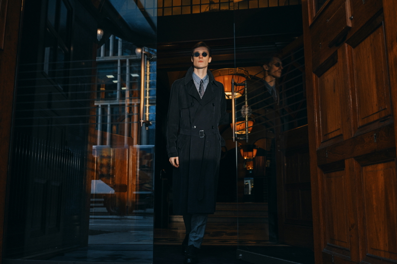 A sleek vision, Tommaso de Benedictis models a Giorgio Armani herringbone-jacquard trench coat with a slim-fit striped cotton and silk-blend shirt and silk-jacquard tie.