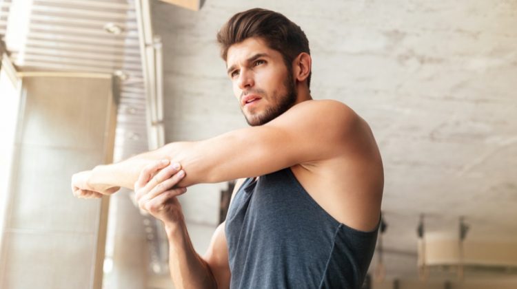 Healthy Man Warming Up Before Working Out