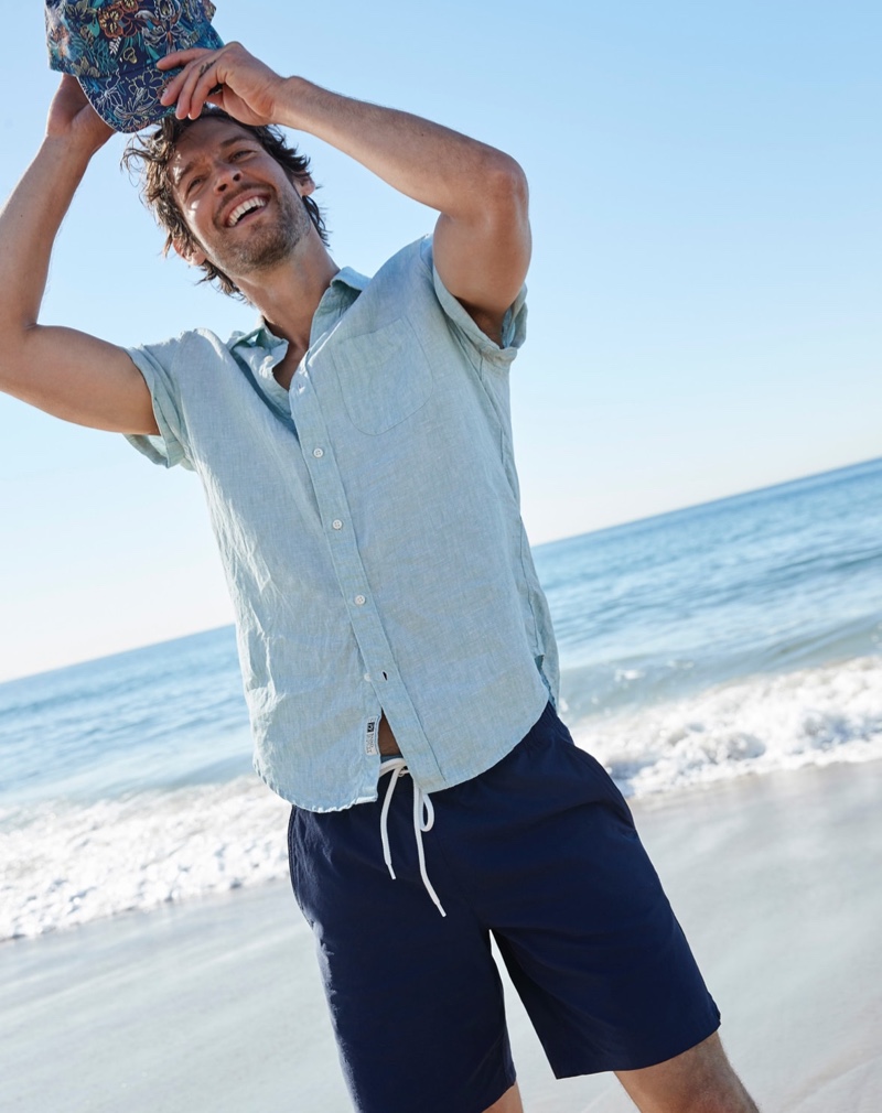 All smiles, Josh Upshaw wears J.Crew's 6" stretch swim trunks in navy.