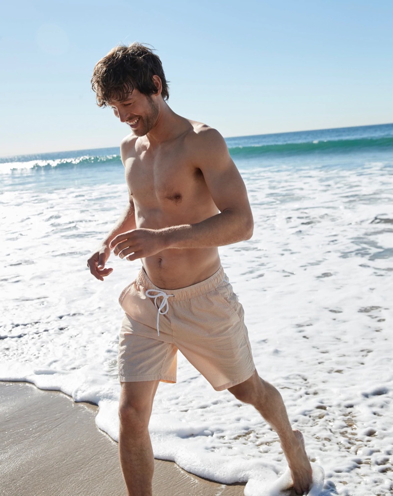 Enjoying a day at the beach, Josh Upshaw wears J.Crew's 6" swim trunk in pink seersucker.