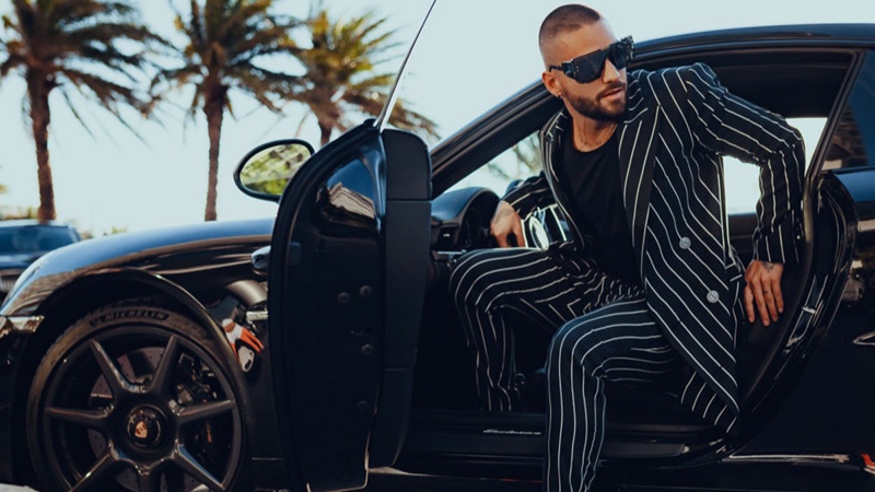 Stepping out of a luxury car, Maluma dons a pinstripe suit from his Balmain capsule collection.