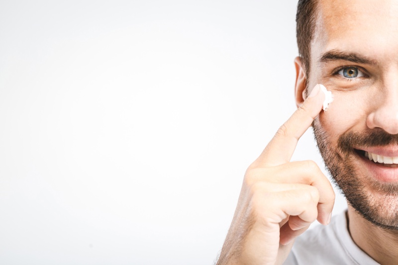 Man Applying Face Cream Moisturizer