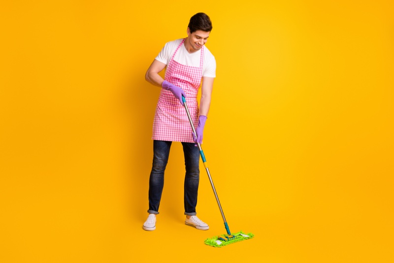 Man Cleaning floor Product Gloves Apron