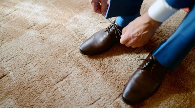 Fortunate Footwear: How Your Shoes Speak Volumes About Your Personality Man Tying Up Leather Dress Shoes