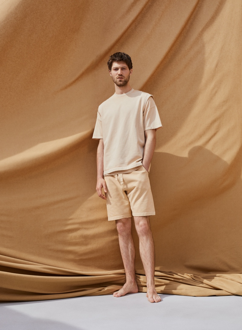 A casual vision, Boyd Gates models a vest, t-shirt, and shorts from Mango Committed's Mineral Dyes capsule collection.