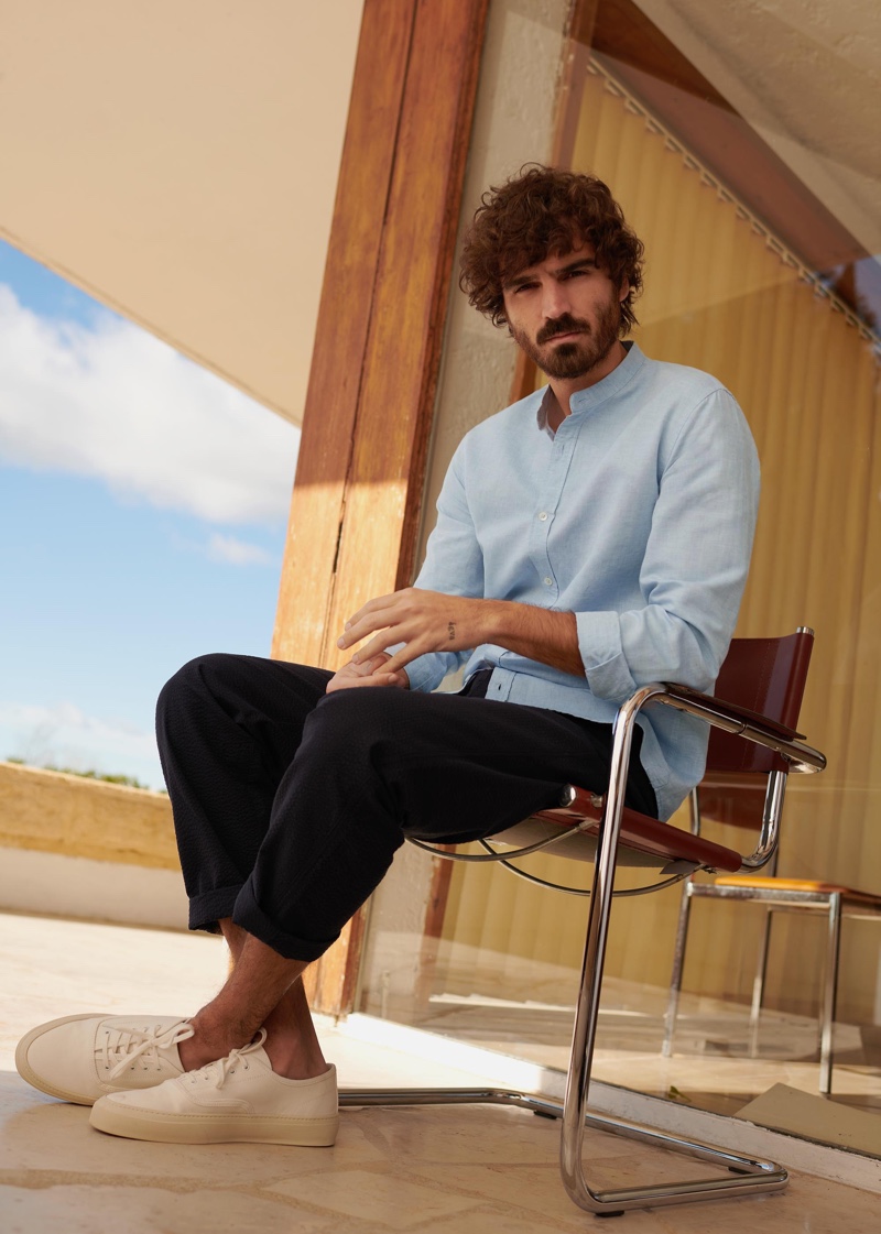 Relaxing in a grandad collar shirt, Nono Marquis dons a look from Octobre's Motel Paradise collection.