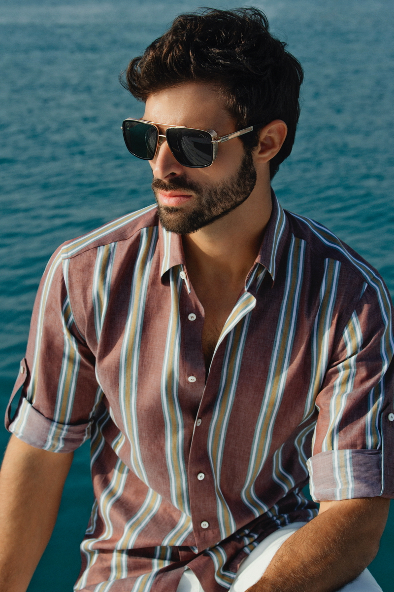 Sporting a striped shirt, Juan Betancourt stars in ZILLI's spring-summer 2021 campaign.