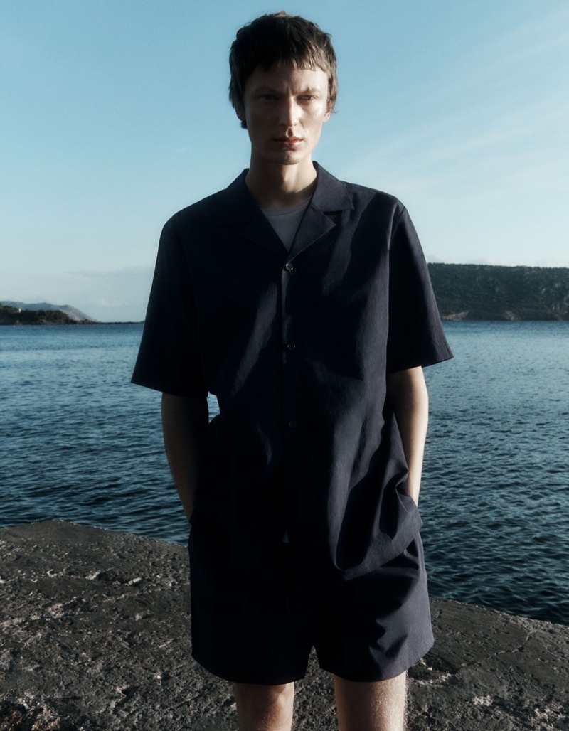 Reuniting with COS for summer, Jonas Glöer models a relaxed camp-collar shirt with drawstring shorts.