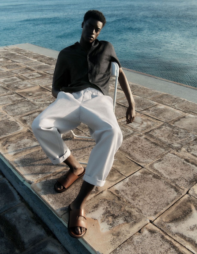 Babacar N'doye rocks a COS camp collar short-sleeve shirt with elasticated tapered leg trousers.