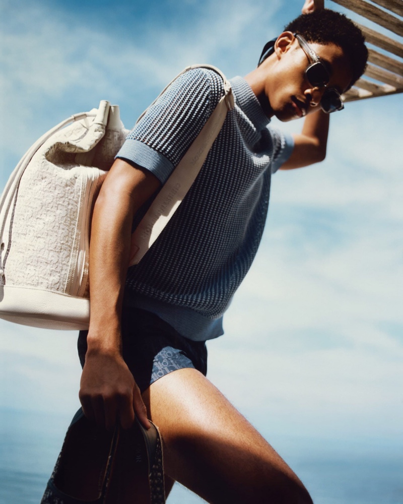 Jecardi Sykes sports a short-sleeve knit, swimwear, and sunglasses from Dior Men's 2021 beachwear collection. » Dior Men is Ready to Hit the Beach with New Collection Jecardi Sykes sports a short-sleeve knit, swimwear, and sunglasses from Dior Men's 2021 beachwear collection.