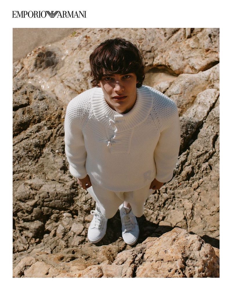 Stepping outdoors, Hernan Cano rocks a sweater from Emporio Armani's spring-summer 2021 sustainable capsule collection.