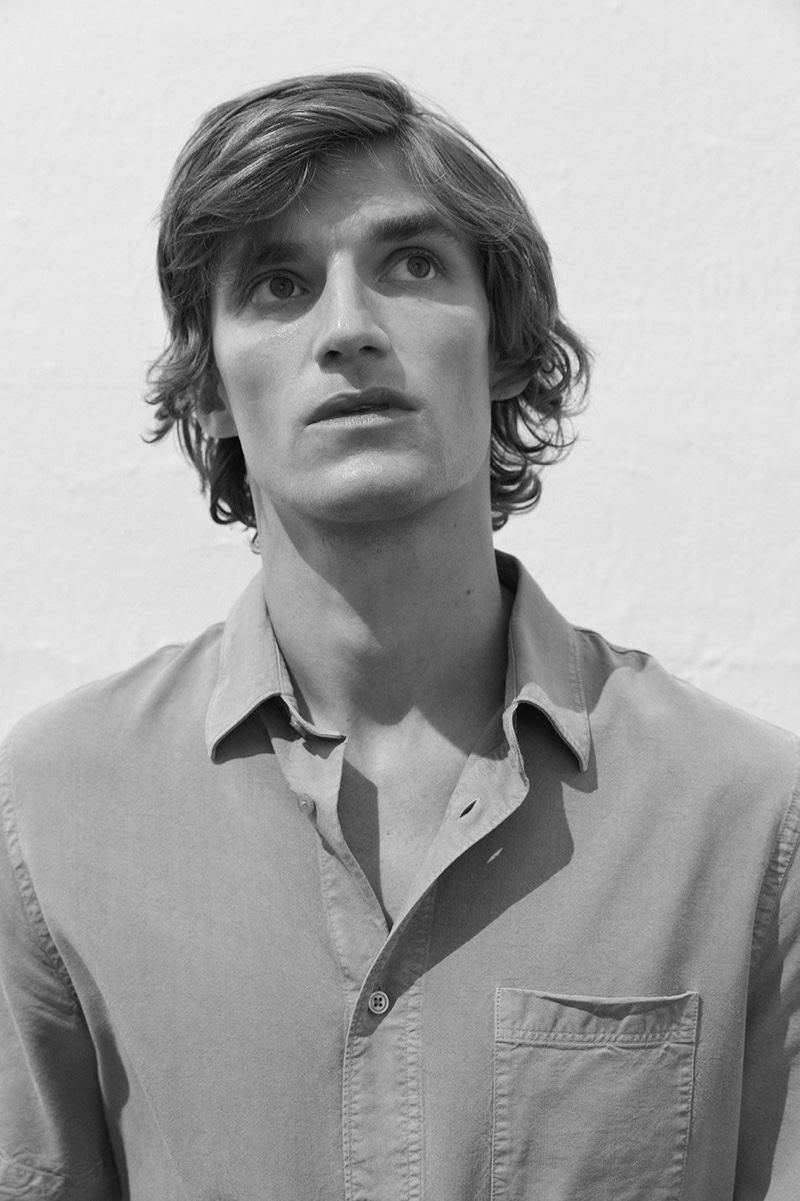 Sporting a sage green shirt, Charlie Westerberg wears Filippa K.