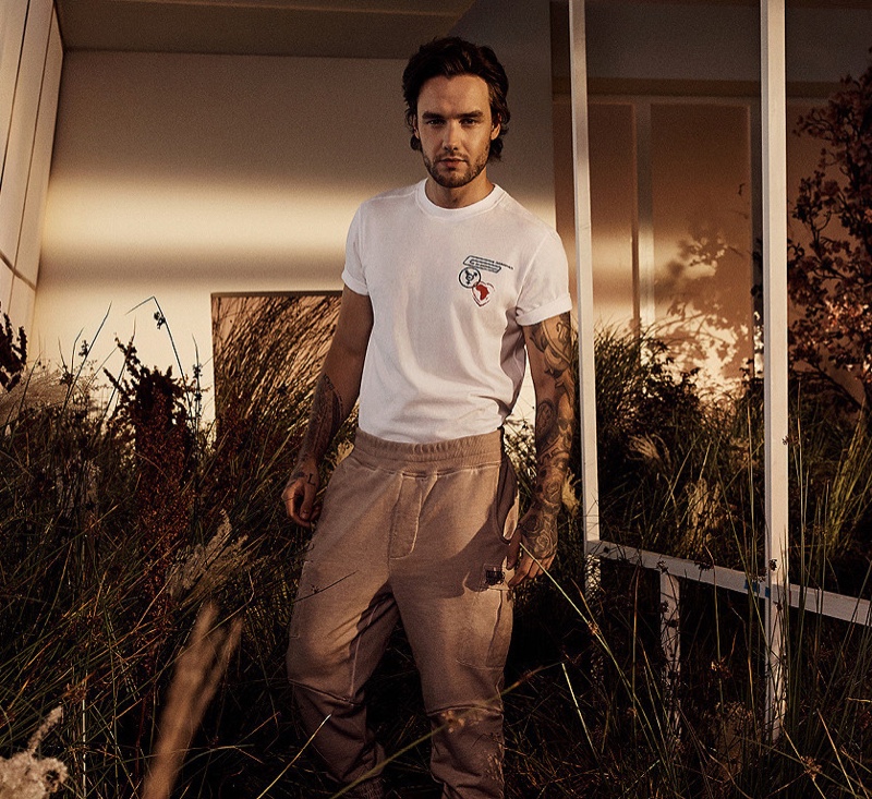 Singer Liam Payne sports a planet artwork t-shirt with cargo pants from his spring-summer 2021 HUGO collection.