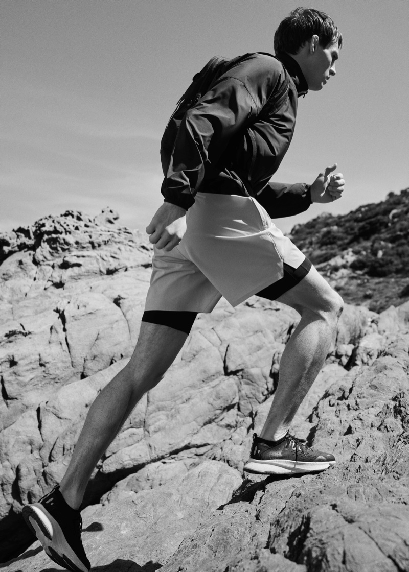 Appearing in a black and white image, Julian Schneyder models a sporty look from Mango Man's Active collection.