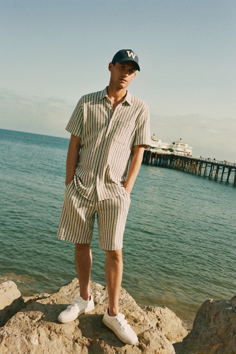 Miles Garber models a matching striped shirt and shorts with a cap from Zara.