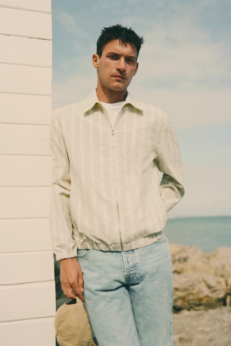 Going casual, Miles Garber rocks a striped jacket with light wash jeans from Zara.