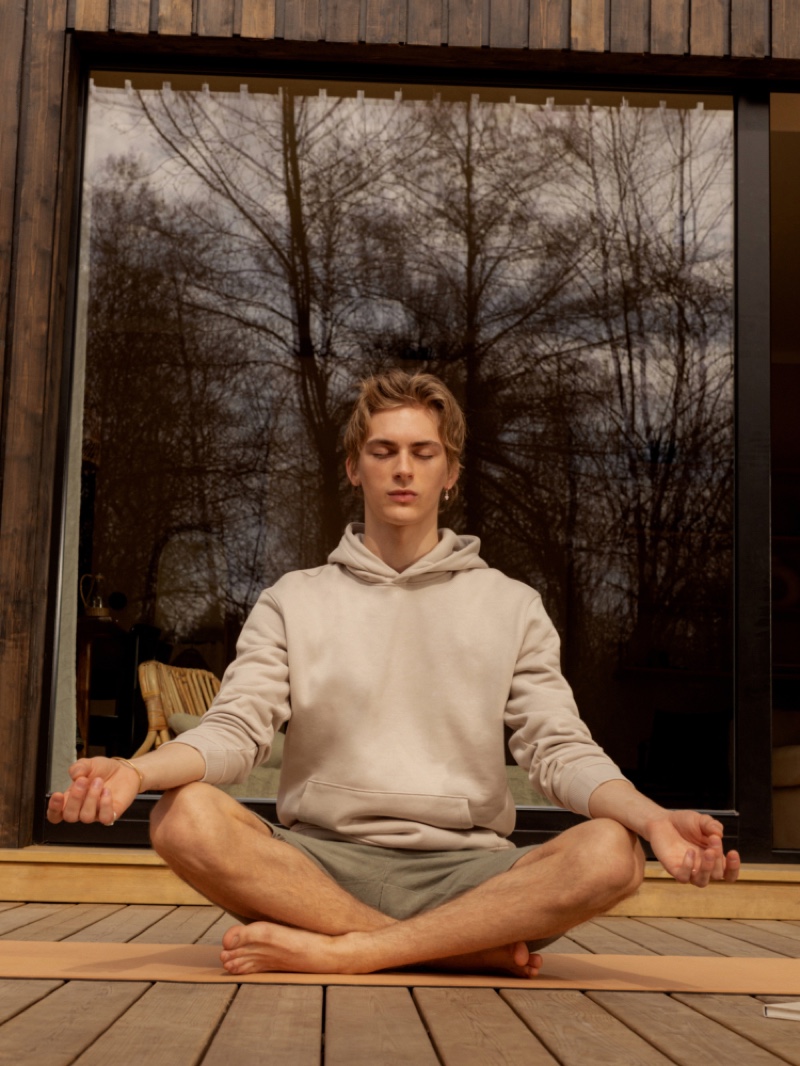 Front and center, Dominik Sadoch dons an organic cotton hoodie with jersey shorts from Reserved Premium. 