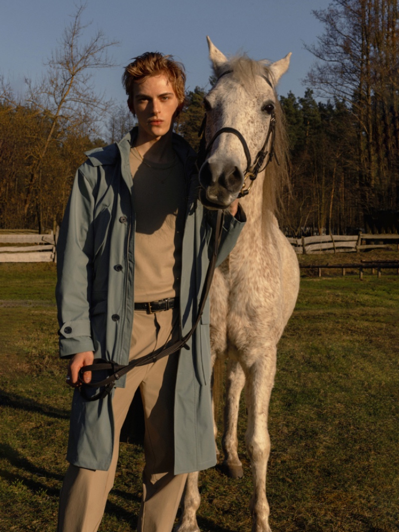 Posing with a horse, Dominik Sadoch sports a look from Reserved Premium. 