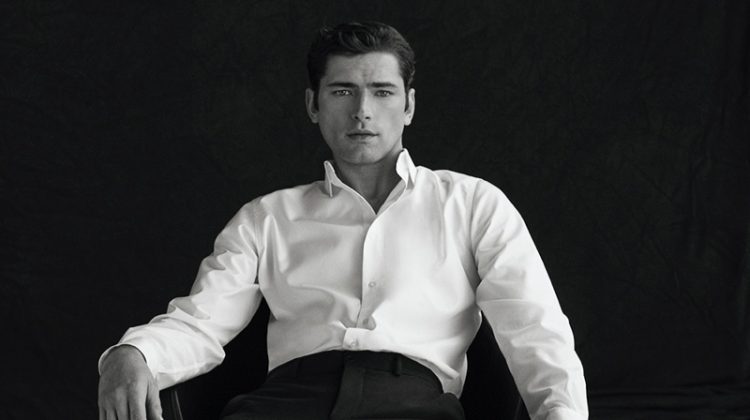 Sean O'Pry models a white dress shirt with black trousers and white sneakers from Massimo Dutti.