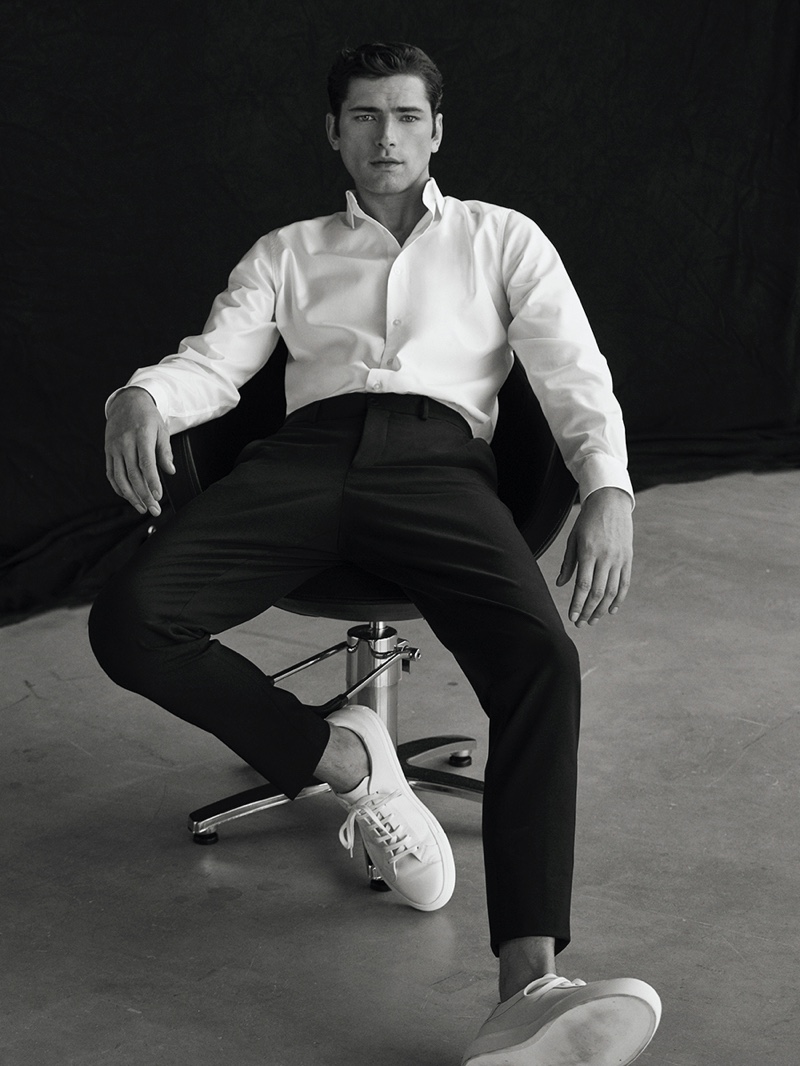 Sean O'Pry models a white dress shirt with black trousers and white sneakers from Massimo Dutti.