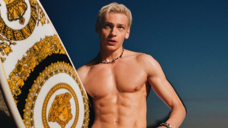 Taking hold of a Versace surfboard and wearing red swim shorts, Lucas Barski fronts the Versace La Vacanza campaign.