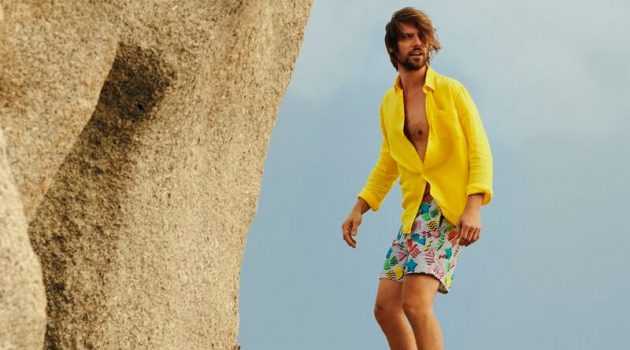 Vilebrequin Kicks Off 50th Anniversary Celebration with Nostalgic Summer James Crabtree models a yellow shirt with Vilebrequin's 1986 Memphis swim trunks.