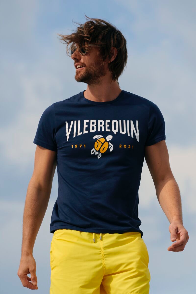 Model James Crabtree wears a VBQ 50 cotton t-shirt with Vilebrequin's solid lemon swim trunks.