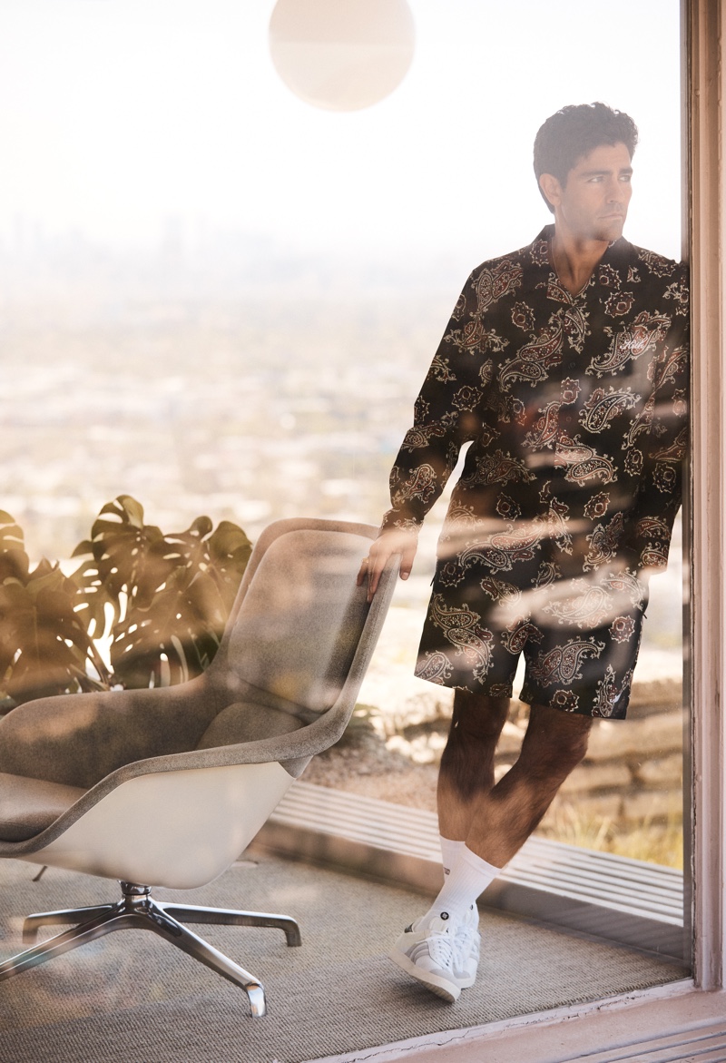 Embracing coordinated style, Adrian Grenier wears a matching shirt and shorts for Kith's summer 2021 campaign.