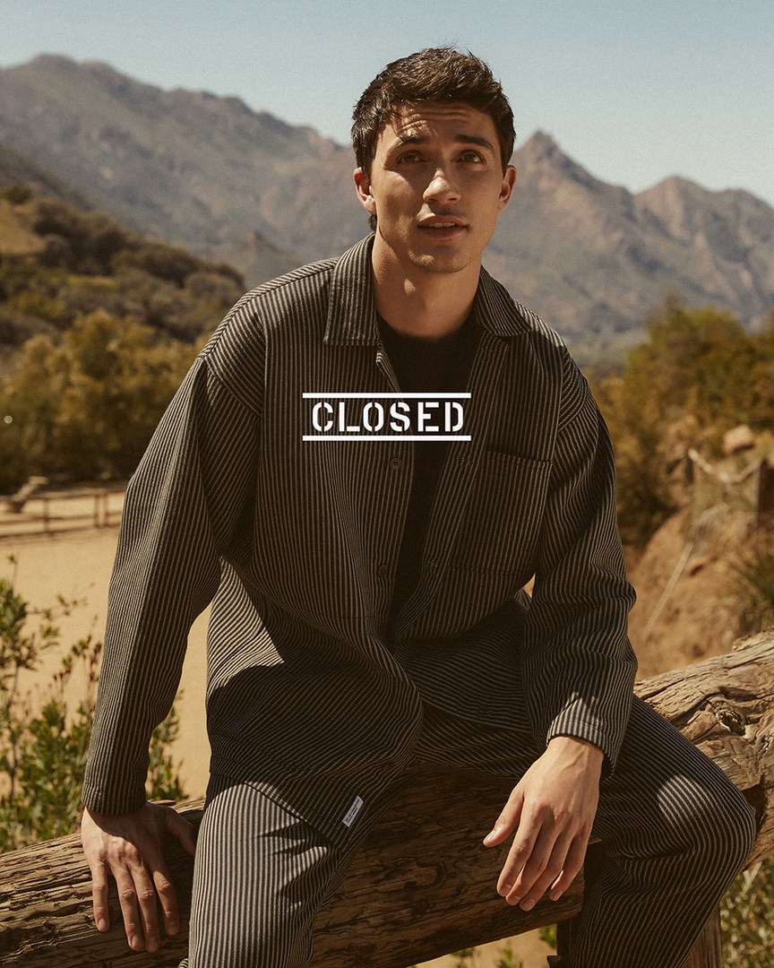 Jacob Bixenman wears a matching striped overshirt and pants for Closed's summer 2021 campaign.