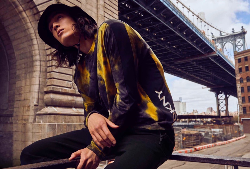 Peter Meyer models a tie-dye sweatshirt with a bucket hat and joggers from DKNY's fall-winter 2021 men's collection. » Pedro, Peter & Raphael Don Urban Style in DKNY Fall '21 Collection Peter Meyer models a tie-dye sweatshirt with a bucket hat and joggers from DKNY's fall-winter 2021 men's collection.