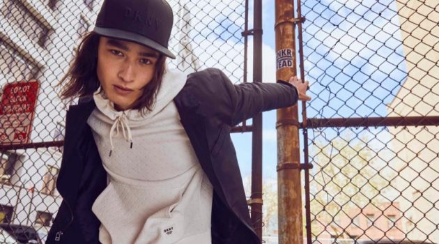 Pedro, Peter & Raphael Don Urban Style in DKNY Fall '21 Collection Layering for the season, Peter Meyer sports a hoodie with a jacket and cap from DKNY's fall-winter 2021 men's collection.