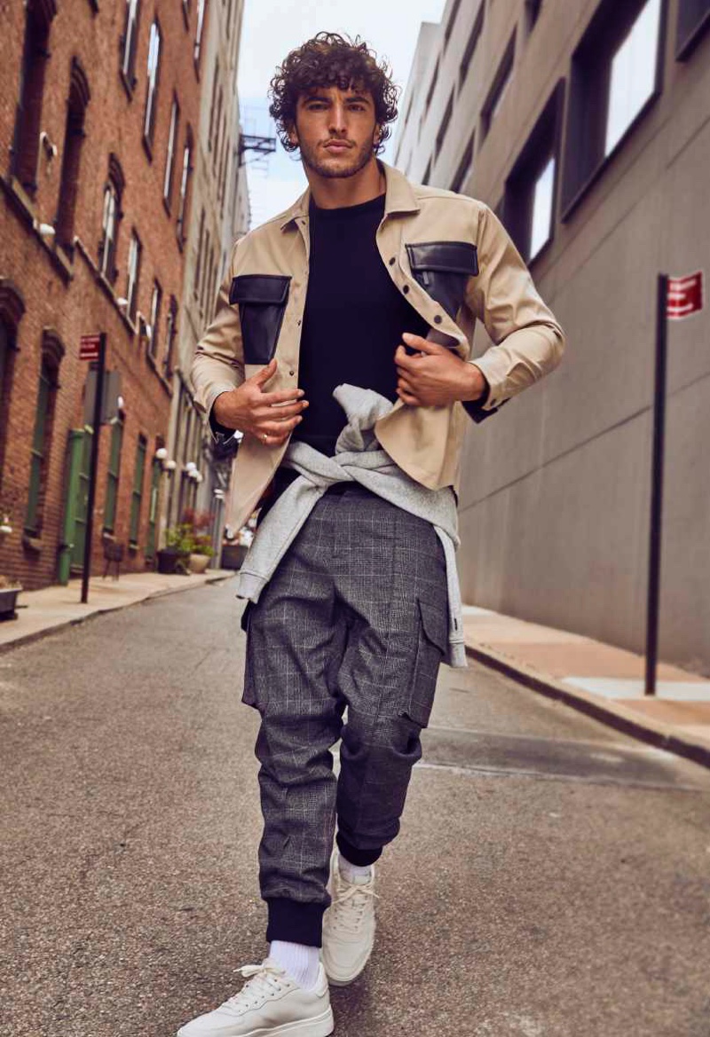 Front and center, Raphael Diogo rocks an overshirt with tweed cargo pant joggers from DKNY's fall-winter 2021 men's collection.