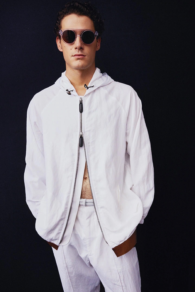 A vision in white, Tommaso Giannoni dons a look from Giorgio Armani's spring-summer 2022 collection.