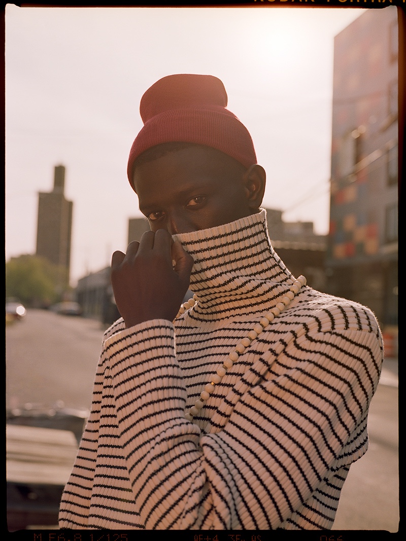 Ibby wears striped turtleneck sweater Teddy Vonranson, beanie Lacoste, and necklace Vanessa's Vintage.