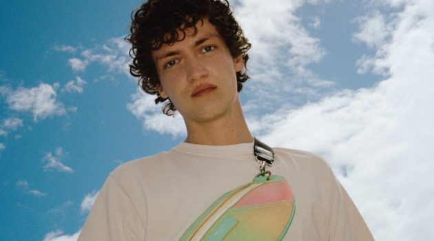Swann Guerrault Sports Jimmy Choo Beach Capsule Collection Appearing in Jimmy Choo's summer 2021 beach capsule campaign, Swann Guerrault sports the brand's York Sunset Mix Degrade Canvas and Sunbleached Calf Leather Belt Bag.