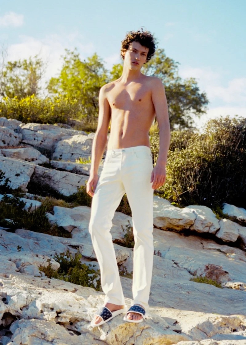A shirtless Swann Guerrault wears white jeans with Jimmy Choo's Fitz/M Navy and White JC Logo Jacquard and White Nappa Leather Pool Slides. » Swann Guerrault Sports Jimmy Choo Beach Capsule Collection A shirtless Swann Guerrault wears white jeans with Jimmy Choo's Fitz/M Navy and White JC Logo Jacquard and White Nappa Leather Pool Slides.