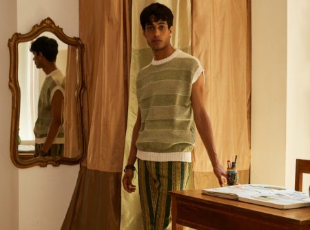 Matteo Tagliabue wears a striped sweater vest and patterned pants from Luca Larenza's spring-summer 2022 collection.