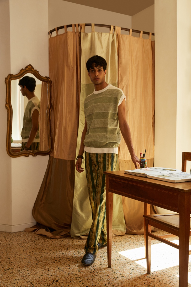 Matteo Tagliabue wears a striped sweater vest and patterned pants from Luca Larenza's spring-summer 2022 collection.