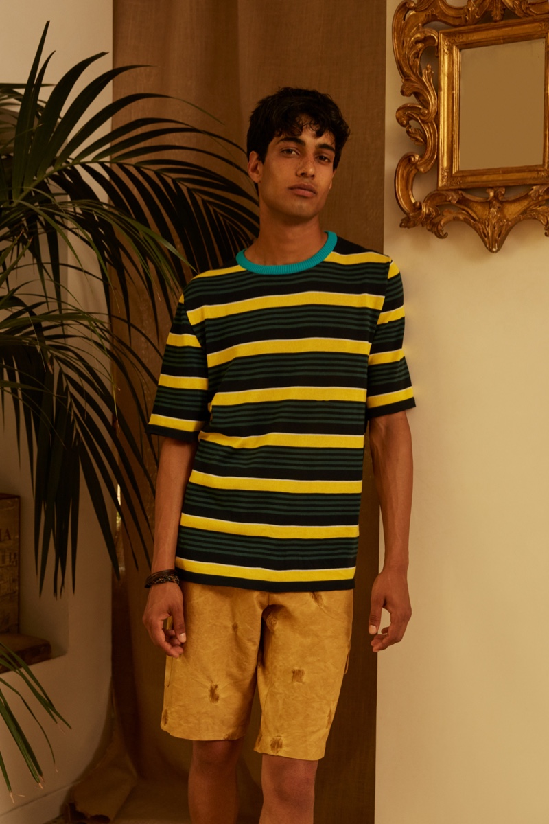 Going casual, Matteo Tagliabue models a striped short-sleeve knit with shorts from Luca Larenza's spring-summer 2022 collection.