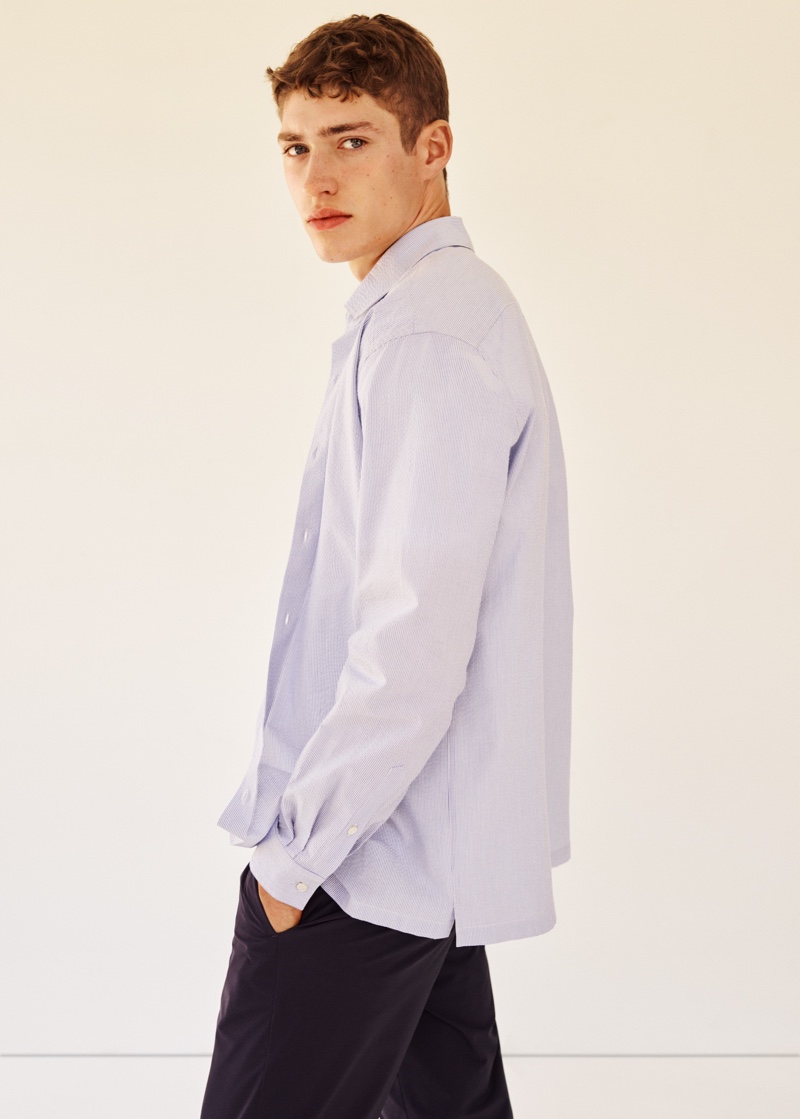 Photographed from the side, Valentin Humbroich wears an oversized shirt with trousers from Mango Man's Clean collection.