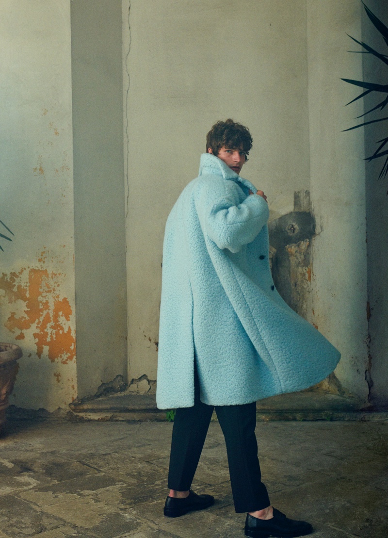 Stepping out for Mytheresa's pre-fall 2021 men's campaign, Erik Van Gils makes a statement in an oversized Prada coat with Jil Sander pants.