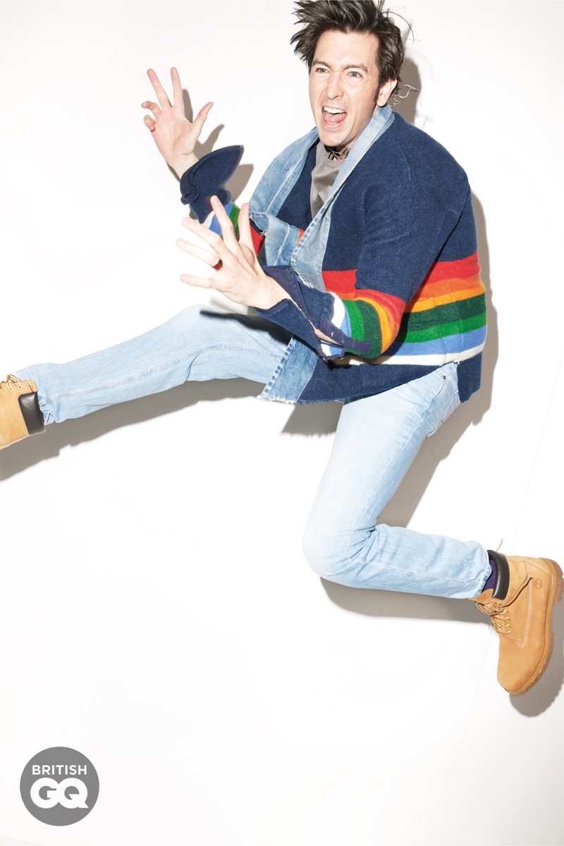 Spazzing out, Nicholas Braun dons a rainbow-striped cardigan by Greg Lauren. Gracing British GQ's pages, he also wears a Giorgio Armani sweatshirt, Brunello Cucinelli jeans, Timberland boots, and UNIQLO socks. Matthew Marden accessorizes Braun in a Caputo & Co. necklace with Miansai rings.