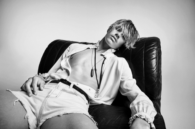 Romeo Beckham models short denim cut-off shorts for Saint Laurent's denim campaign.