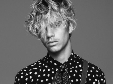 Romeo Beckham rocks a printed shirt and polka dot bow for Saint Laurent's fall-winter 2021 men's campaign.