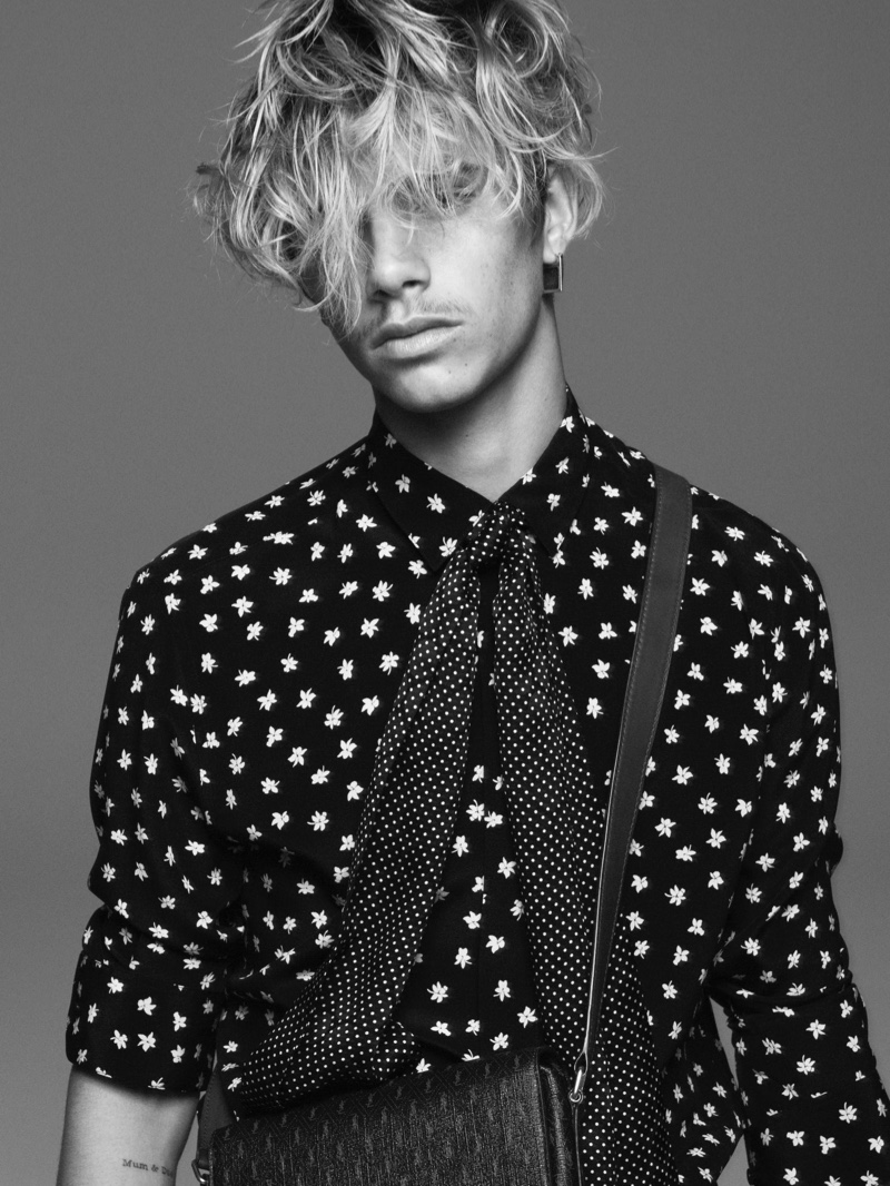 Romeo Beckham rocks a printed shirt and polka dot bow for Saint Laurent's fall-winter 2021 men's campaign.