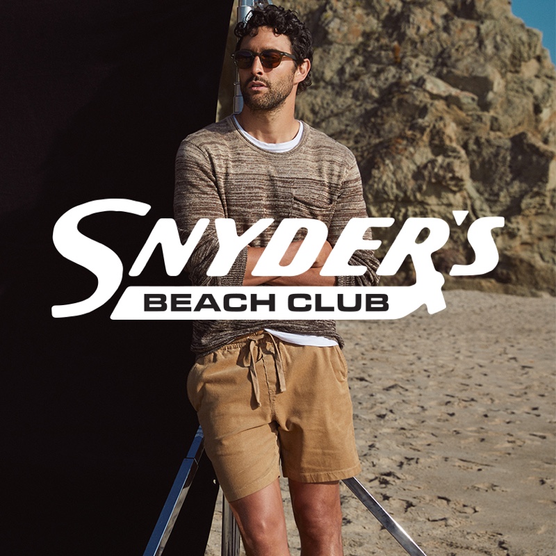 Hitting the beach, Noah Mills wears Todd Snyder's cotton-linen ombre beach sweater in brown with 7" washed corduroy weekend shorts in khaki.