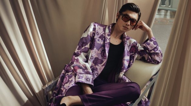Tom Ford Channels '70s LA for Mr Porter Summer Capsule Relaxing, Hidetatsu Takeuchi wears a Tom Ford piped floral-print silk-twill robe with purple leather-trimmed velvet loafers and brown round-frame tortoiseshell acetate sunglasses.
