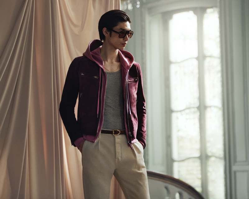 A sporty but luxurious vision, Hidetatsu Takeuchi sports Tom Ford's lilac zip-up hoodie, purple suede blouson jacket, brown aviator-style tortoiseshell acetate sunglasses, and slim-fit pleated stretch-denim jeans.